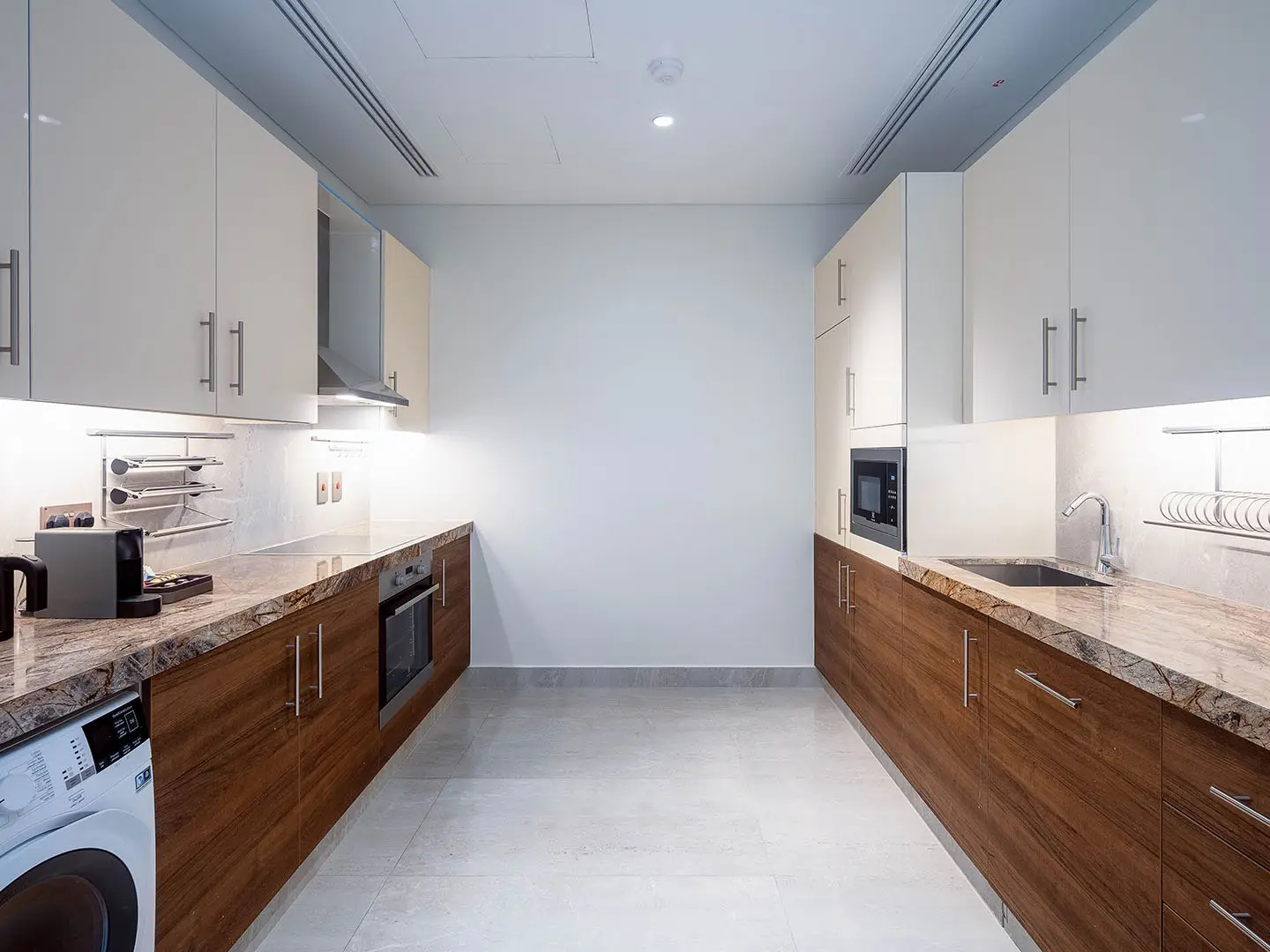 Modern kitchen with wood cabinets and marble counters