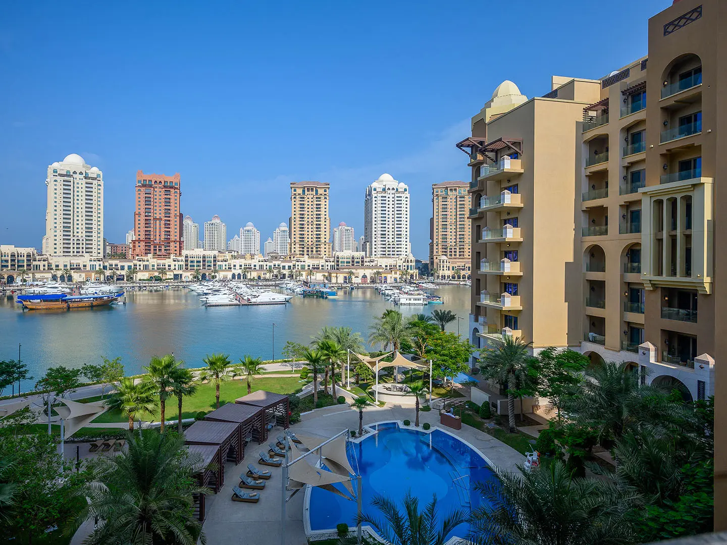 Waterfront view with pool and high-rise buildings