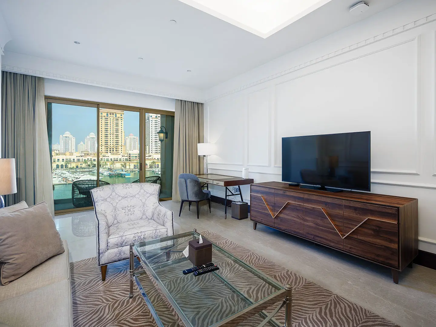 Modern living room with marina view through glass doors