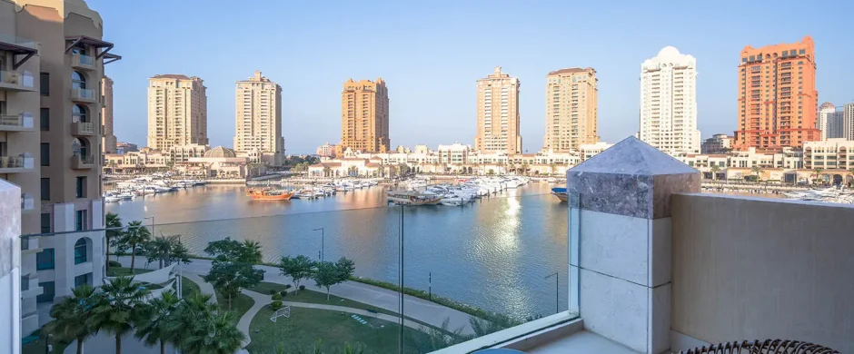 Balcony seating facing tall buildings and water
